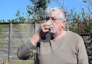 Man blowing his nose.