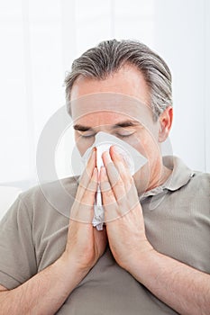 Man blowing his nose