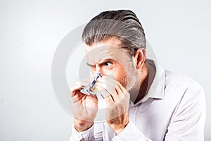 Man blowing his nose into the banknotes -