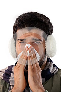 Man blowing his nose with tissue paper