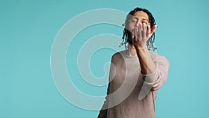 Man blowing kisses to camera, being flirty, studio background