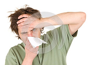 Man blowing nose with handkerchief