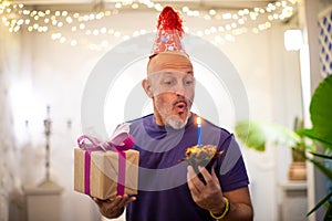 Man blows out a candle on the cake