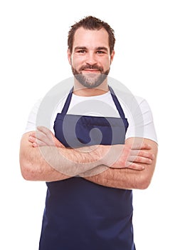 Man in blue apron with arms crossed