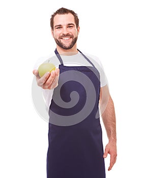 Man with blue apron and green apple