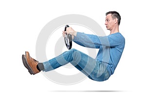Man in blue casual wear drives a car with a steering wheel, isolated on white background. Auto driver concept