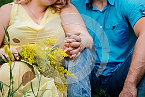 Man in blue clothes and woman in yellow dress are sitting