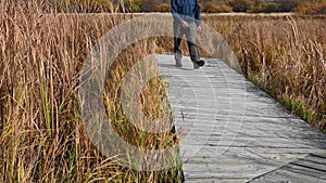 Man, with a blue coat walking towards camera