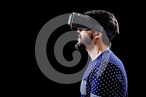 Man in blue dotted T-shirt wearing virtual reality 3d-headset