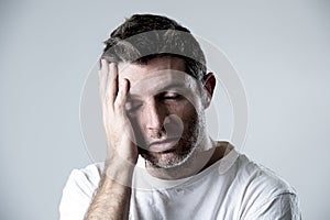 Man with blue eyes sad and depressed looking lonely and suffering depression feeling sorrow photo