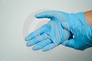 Man in blue gloves with wrist pain from using computer on white background.health care and medical concept,Office syndrome hand