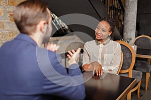 A man in a blue jacket is taking an interview