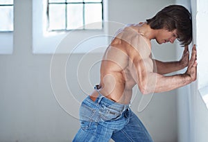 A man in blue jeans in natural light.