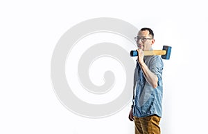 A man in blue shirt holding a big hammer on his shoulder and smiling