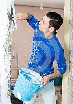 Man puttying doorway in apartment photo