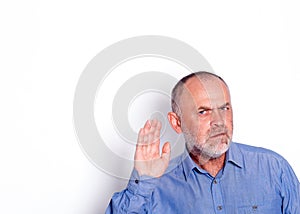 The man in blue shirt putting his hand near his ear on white background