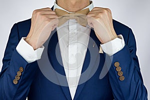 Man blue suit bowtie, brooch, pocket square