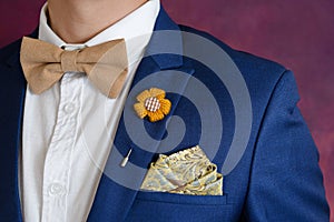 Man in blue suit bowtie, pocket square