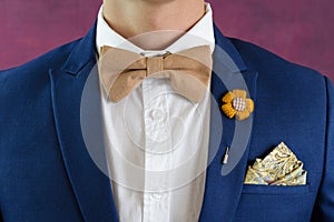 Man in blue suit bowtie, pocket square