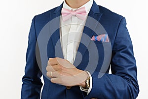 Man in blue suit bowtie, pocket square