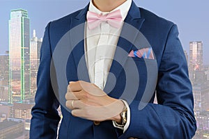 Man in blue suit bowtie, pocket square