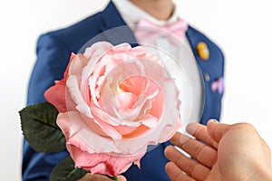 Man in blue suit carry flowers