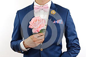 Man in blue suit carry flowers