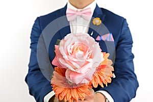 Man in blue suit carry flowers