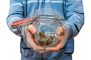 Man in blue sweatshirt holding money jar with coins