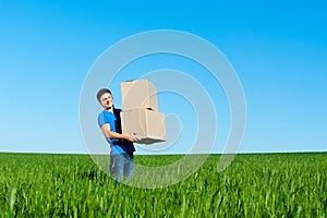 Man in blue t-shirt carrying boxes