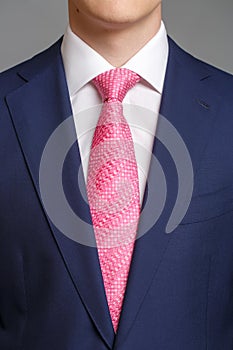 Man in blue tuxedo with pink tie