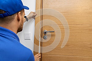 Man installing door architrave