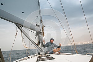 A man on board a sailing yacht.
