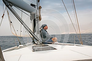 A man on board a sailing yacht.