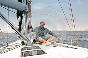 A man on board a sailing yacht.