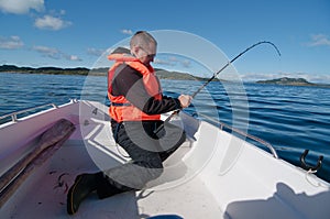 Man in a boat with fishing rod