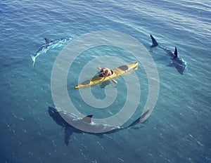 A man in a boat, kayak. was trapped in the middle of the ocean surrounded by sharks.