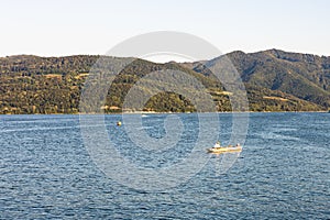 Man in boat relaxing and fishing on Danube river on a sunny day in Orsova, Romania, 2020