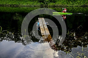 Man boating on river in summer day.