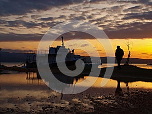 Man and a boats in sunset