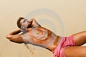 Man Body On Beach. Summer Male Lying On Sand At Resort