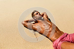 Man Body On Beach. Summer Male Lying On Sand At Resort