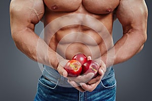 Man bodybuilder hands holding a fresh peaches