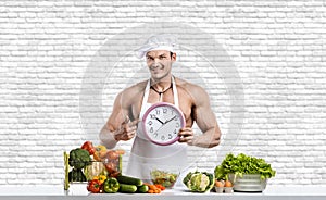 Man bodybuilder in white toque blanche and cook