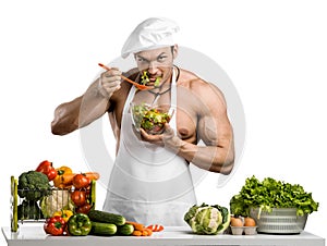 Man bodybuilder in white toque blanche and cook protective apron