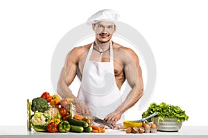 Man bodybuilder in white toque blanche and cook protective apron