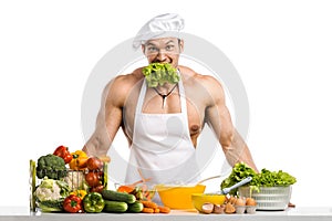 Man bodybuilder in white toque blanche and cook protective apron