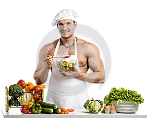 Man bodybuilder in white toque blanche and cook protective apron