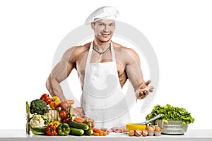 Man bodybuilder in white toque blanche and cook protective apron