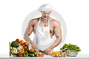 Man bodybuilder in white toque blanche and cook protective apron